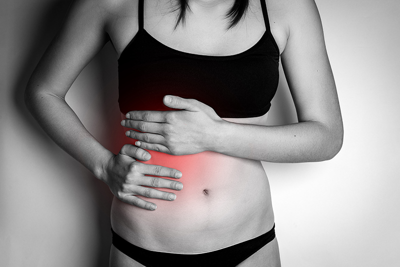 A woman experiencing pain in her liver