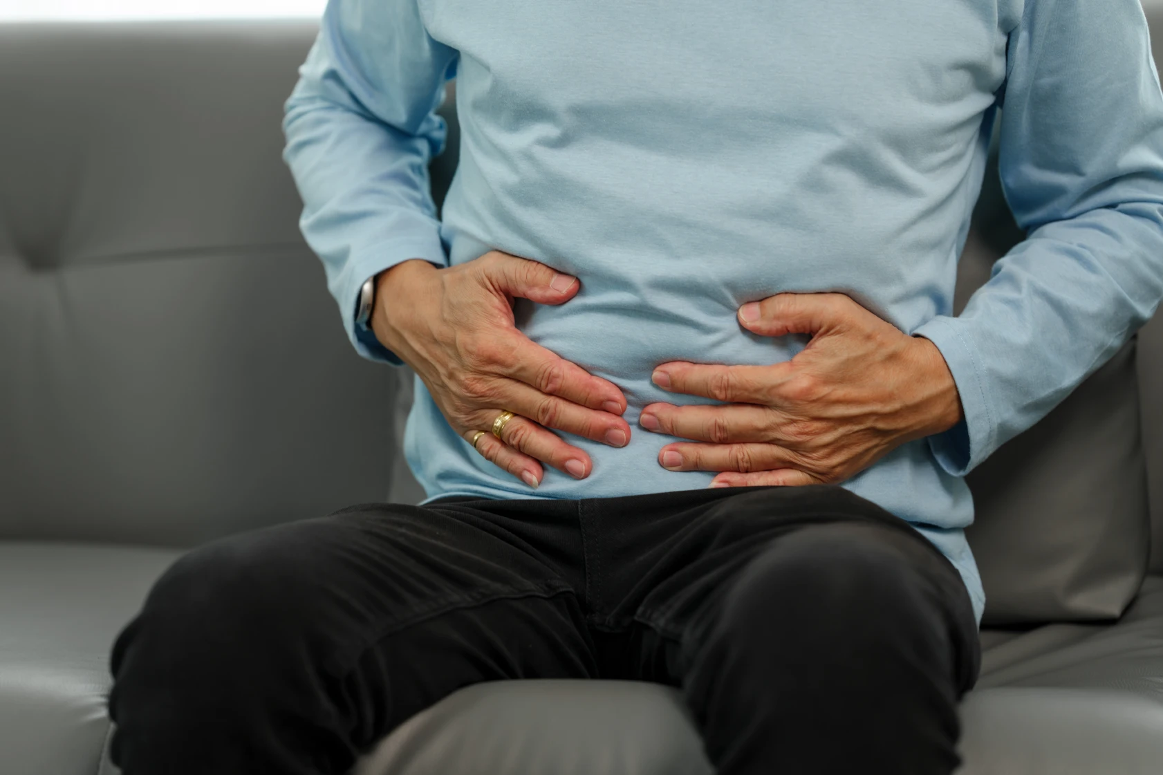 An elderly man experiencing gastrointestinal discomfort